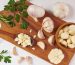 garlic with rosemary, parsley and peppercorn  on a wooden board isolated on white background. Top view. Flat lay pattern. freshly picked from home growth organic garden. Food concept.